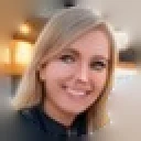 Caren, a student: a smiling woman with long fair hair in a dark top, in a warmly lit room
