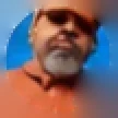 Rob Peterson, a student: a bearded man with sunglasses pushed up on his head, in an orange top
