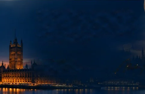 The Houses of Parliament and Westminster at dusk, lit along the river