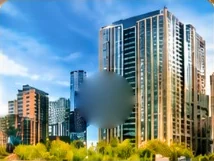 Glass apartment towers above green trees under a blue sky